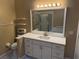 Updated bathroom with white cabinets, quartz countertops, and a large mirror at 371 Lexingdale Dr, Orlando, FL 32828