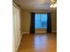 Bedroom with wood floors and window with blinds at 371 Lexingdale Dr, Orlando, FL 32828