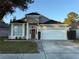 One-story house with a two-car garage and manicured lawn at 371 Lexingdale Dr, Orlando, FL 32828