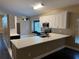 Eat-in kitchen with white and dark cabinets and quartz countertops at 371 Lexingdale Dr, Orlando, FL 32828