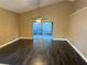 Spacious living room with dark laminate flooring and sliding doors to patio at 371 Lexingdale Dr, Orlando, FL 32828