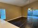 Spacious living room with dark laminate flooring and sliding doors to patio at 371 Lexingdale Dr, Orlando, FL 32828