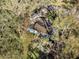 Aerial view of a blue house nestled among trees at 4935 Sand Mountain Loop Rd, Auburndale, FL 33823