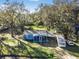 Blue house with covered carport and large backyard at 4935 Sand Mountain Loop Rd, Auburndale, FL 33823