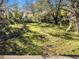 Large backyard with mature trees and grassy area at 4935 Sand Mountain Loop Rd, Auburndale, FL 33823