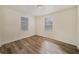 Bright bedroom with wood-look floors and two windows at 4935 Sand Mountain Loop Rd, Auburndale, FL 33823