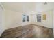 Spacious bedroom with wood-look floors and two windows at 4935 Sand Mountain Loop Rd, Auburndale, FL 33823