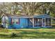 Blue house with screened porch and yard at 4935 Sand Mountain Loop Rd, Auburndale, FL 33823