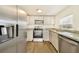 Modern kitchen with stainless steel appliances and granite countertops at 4935 Sand Mountain Loop Rd, Auburndale, FL 33823