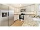 Modern kitchen with stainless steel appliances and granite countertops at 4935 Sand Mountain Loop Rd, Auburndale, FL 33823