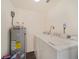 Laundry room with washer, dryer, and water heater at 4935 Sand Mountain Loop Rd, Auburndale, FL 33823