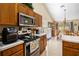 Kitchen with stainless steel appliances and view into dining area at 5556 Elizabeth Rose Sq, Orlando, FL 32810