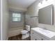 Updated bathroom with a tub, toilet and vanity at 5711 Bolling Dr, Orlando, FL 32808