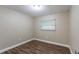 Cozy bedroom with wood-look floors and window at 5711 Bolling Dr, Orlando, FL 32808