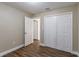 Well-lit bedroom with double door closet and wood floors at 5711 Bolling Dr, Orlando, FL 32808