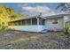 Rear view of house showing screened porch and yard at 5711 Bolling Dr, Orlando, FL 32808