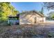 Side view of house with screened porch and yard at 5711 Bolling Dr, Orlando, FL 32808