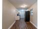 Newly renovated kitchen with white cabinets, granite countertops, and dark wood floors at 5711 Bolling Dr, Orlando, FL 32808