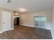 Living room with hardwood floors, neutral walls, and sliding glass doors at 5711 Bolling Dr, Orlando, FL 32808