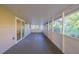Large screened porch with concrete flooring and sliding glass door at 5711 Bolling Dr, Orlando, FL 32808