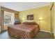 King-size bed, TV, and window with curtains at 6403 Parc Corniche Dr # 4309, Orlando, FL 32821