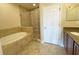 Bathroom with soaking tub, shower, and double vanity at 7580 Toscana Blvd # 834, Orlando, FL 32819