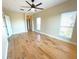 Bright bedroom with hardwood floors and multiple windows at 7580 Toscana Blvd # 834, Orlando, FL 32819