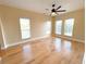 Bright bedroom with hardwood floors and large windows at 7580 Toscana Blvd # 834, Orlando, FL 32819