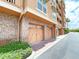 Exterior view of building with multiple garages at 7580 Toscana Blvd # 834, Orlando, FL 32819