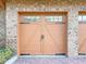 Double car garage with brick facade and carriage style doors at 7580 Toscana Blvd # 834, Orlando, FL 32819