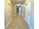 Bright hallway with tile flooring, leading to laundry and other rooms at 7580 Toscana Blvd # 834, Orlando, FL 32819