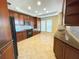 Spacious kitchen with dark wood cabinets, granite countertops, and modern appliances at 7580 Toscana Blvd # 834, Orlando, FL 32819