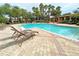 Community pool with lounge chairs and patio area at 7580 Toscana Blvd # 834, Orlando, FL 32819