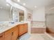 Large bathroom with double sinks, corner tub, and shower at 8737 The Esplanade # 65, Orlando, FL 32836