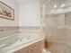 Bathroom features a corner bathtub and a separate shower stall at 8737 The Esplanade # 65, Orlando, FL 32836