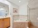 Elegant bathroom with corner soaking tub, separate shower, and double vanity at 8737 The Esplanade # 65, Orlando, FL 32836