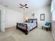 Charming bedroom with double bed, ceiling fan, and sitting area at 8737 The Esplanade # 65, Orlando, FL 32836