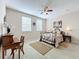 Bright bedroom with ceiling fan, double bed, and ample space at 8737 The Esplanade # 65, Orlando, FL 32836