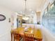 Bright dining area with wood table and chairs, adjacent to kitchen at 8737 The Esplanade # 65, Orlando, FL 32836