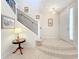 Elegant entryway with a grand staircase, tiled floors, and decorative lighting at 8737 The Esplanade # 65, Orlando, FL 32836