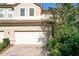 Two-story townhome with a two-car garage and manicured landscaping at 8737 The Esplanade # 65, Orlando, FL 32836