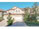 Tan three-story townhome with a two-car garage and nicely landscaped yard at 8737 The Esplanade # 65, Orlando, FL 32836