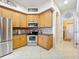 Spacious kitchen with stainless steel appliances and light wood cabinets at 8737 The Esplanade # 65, Orlando, FL 32836