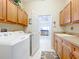 Laundry room with washer, dryer, and cabinets for storage at 8737 The Esplanade # 65, Orlando, FL 32836