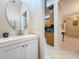 Modern powder room with white vanity and oval mirror at 8737 The Esplanade # 65, Orlando, FL 32836