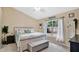 Bright bedroom with a king-size bed and backyard view at 100 Kelly Cir, Sanford, FL 32773