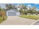 Two-car garage and driveway, gray house with a manicured lawn at 100 Kelly Cir, Sanford, FL 32773