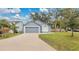 Gray house with a two-car garage and well-maintained lawn at 100 Kelly Cir, Sanford, FL 32773