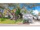 House exterior features a light-colored facade, landscaping, and a driveway at 100 Ledbury Dr, Longwood, FL 32779