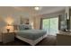 Main bedroom with a queen bed and access to a balcony at 1001 Park Ridge Cir, Kissimmee, FL 34746